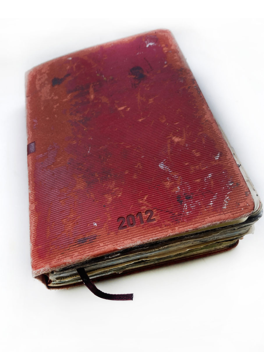 Closed Agenda 2012 showing its worn red cover